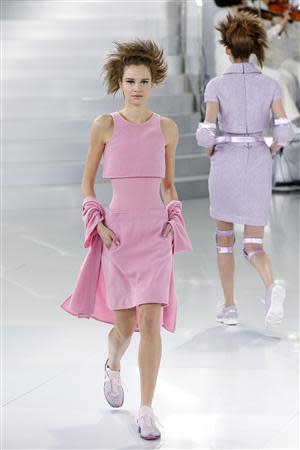 Chanel models in sorbet pink skip down stairs at Paris fashion show