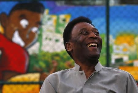 Brazilian soccer legend Pele laughs during the inauguration of a refurbished soccer field at the Mineira slum in Rio de Janeiro September 10, 2014. REUTERS/Ricardo Moraes/Files