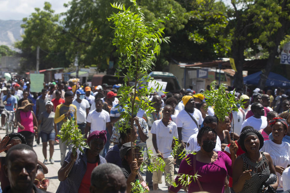 Demonstrators march demanding peace and security in La Plaine neighborhood of Port-au-Prince, Haiti, Friday, May 6, 2022. (AP Photo/Odelyn Joseph)