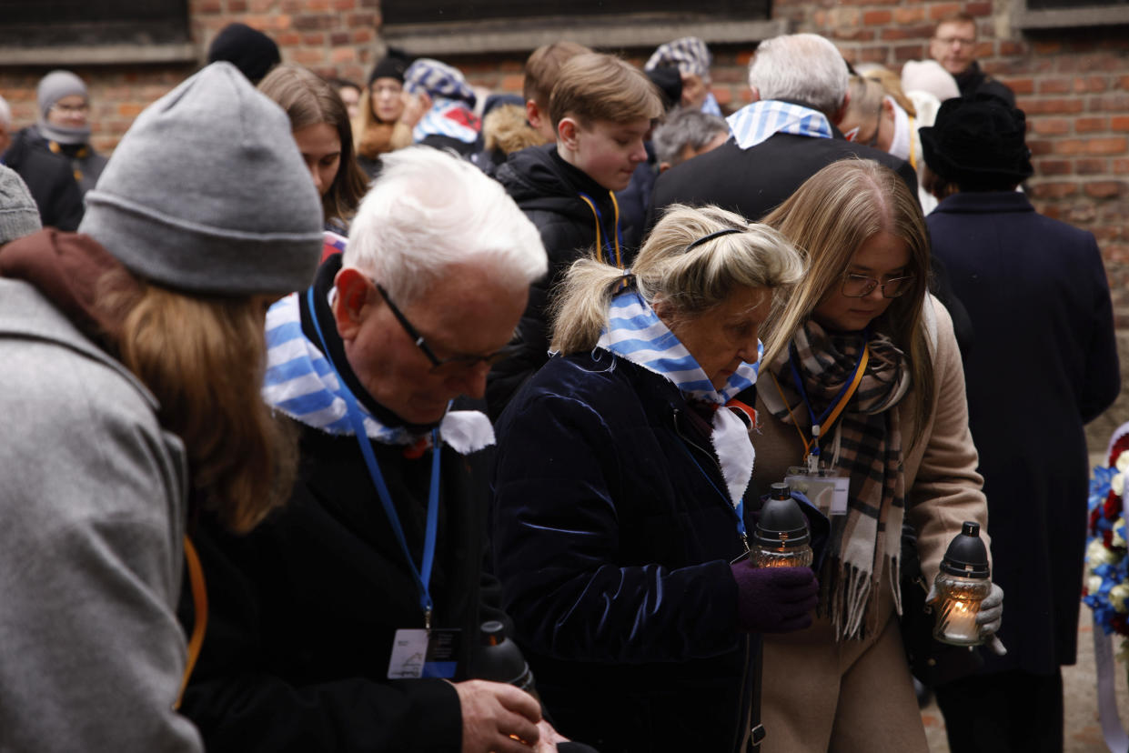 Holocaust survivors and former Auschwitz inmates attend a wreath lying ceremony in front of the Death Wall in the former Nazi German concentration and extermination camp Auschwitz during ceremonies marking the 78th anniversary of the liberation of the camp in Oswiecim, Poland, Friday, Jan. 27, 2023. (AP Photo/Michal Dyjuk)