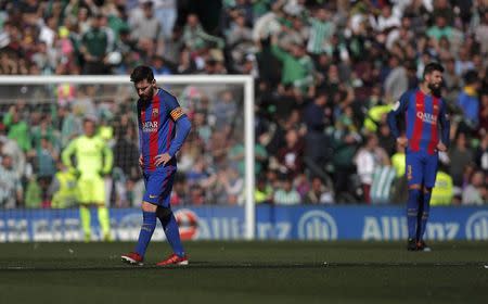 Football Soccer - Real Betis v Barcelona - Spanish Liga Santander - Benito Villamarin stadium, Seville, Spain - 29/01/2017 Barcelona's Lionel Messi and Gerard Pique react after Real Betis scored a goal during the match. REUTERS/Jon Nazca