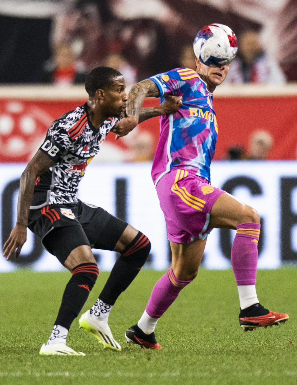 Toronto FC forward Federico Bernardeschi, right, vies for the ball against New York Red Bulls defender Kyle Duncan, left, during an MLS soccer match Saturday, Oct. 7, 2023, in Harrison, N.J. (AP Photo/Eduardo Munoz Alvarez)