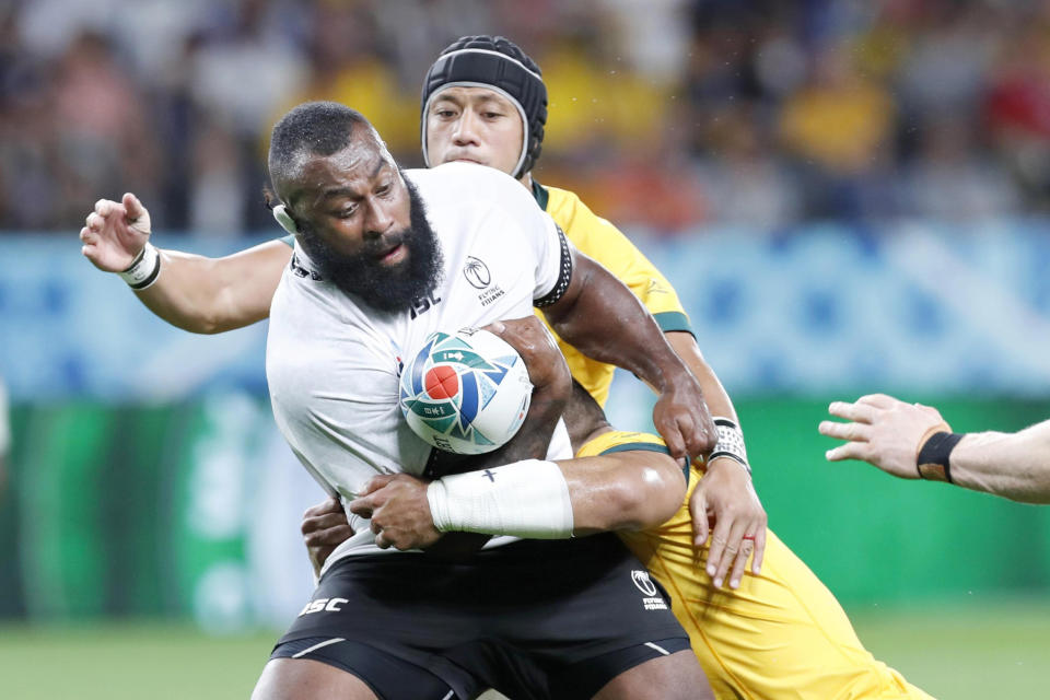 Fiji’s Peni Ravai carris the ball while being tackled during the Rugby World Cup Pool D game at Sapporo Dome between Australia and Fiji in Sapporo, northern Japan, Saturday, Sept. 21, 2019. (Masanori Takei/Kyodo News via AP)