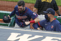 Minnesota Twins' Jake Cave (60) is greeted as he enters the dugout after scoring on a fly ball by Minnesota Twins' Marwin Gonzalez in the second inning of a baseball game, Wednesday, Aug. 5, 2020, in Pittsburgh. The original call was that the fly ball was foul, but upon review the ball was ruled fair and Cave scored from second. (AP Photo/Keith Srakocic)