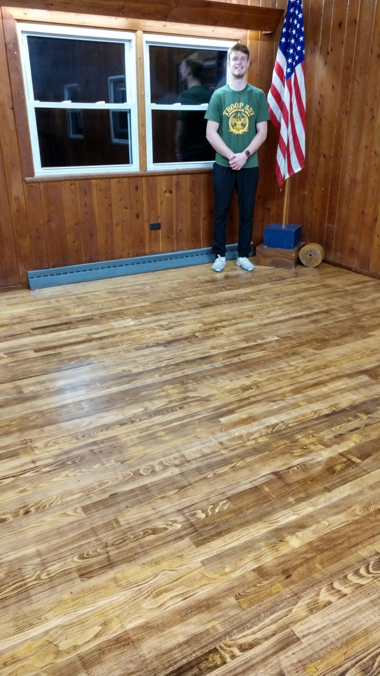 Eagle Scout candidate Cam Stanton admires in early November the work he and fellow Scouts have done on the refinished floor of Loudonville's Youth Building. Refinishing the floor was a major part of Stanton's Eagle Scout project with Troop 537 in Loudonville. Loudonville Council recognized Stanton at its Dec. 6 meeting.