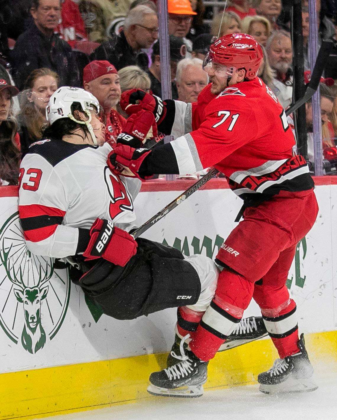 The Carolina Hurricanes Jesper Fast (71) checks the New Jersey Devils Ryan Graves (33) into the boards in the first period during Game 2 of their second round Stanley Cup playoff series on Friday, May 5, 2023 at PNC Arena in Raleigh, N.C.