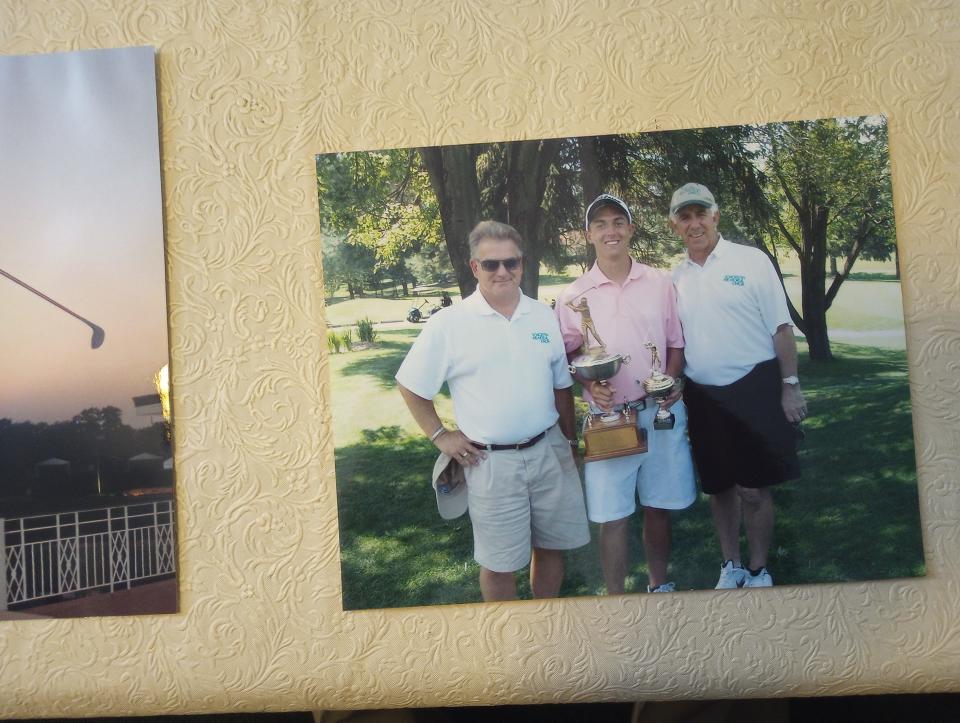 Justin Lower (middle) holds the trophy after winning the 2008 Schorsten Memorial junior golf tournament as a Malone University freshman.