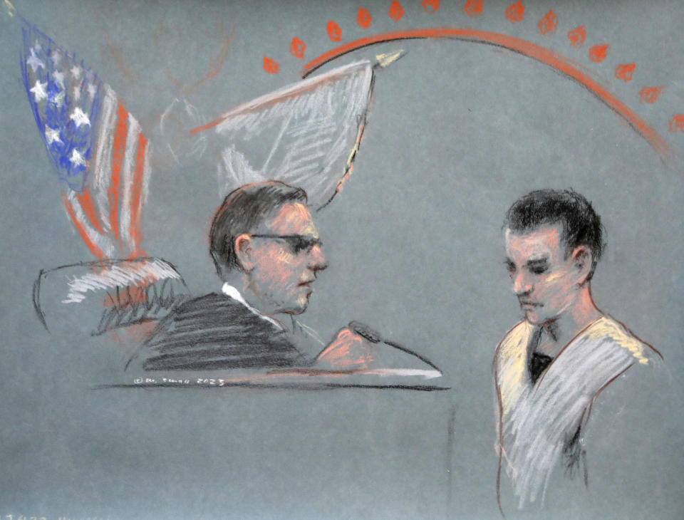 In an illustration in pastels, Jack Teixeira hangs his head in front of a judge, with two flags, one American, in the background.