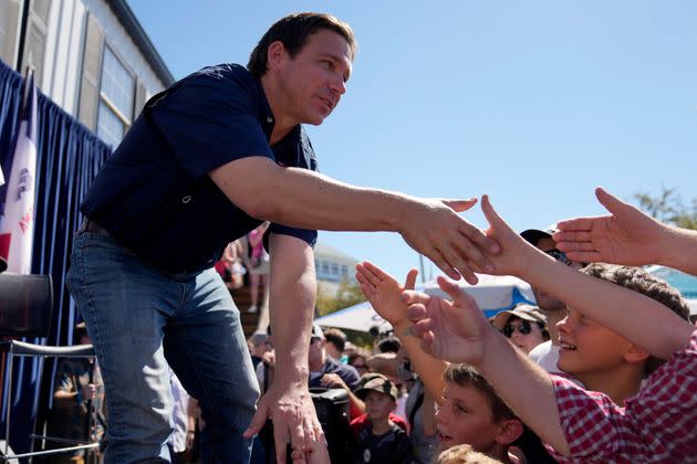 Republican presidential candidate Florida Gov. Ron DeSantis shakes hands with fairgoers after taking part in a 