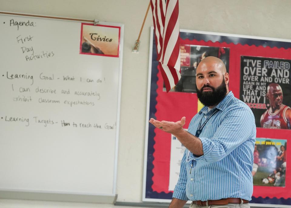 Murray Middle School teacher Logan Hendrix instructs his civics 8th-grade students on the first day of school Wednesday, Aug. 10, 2022, in Port Salerno.