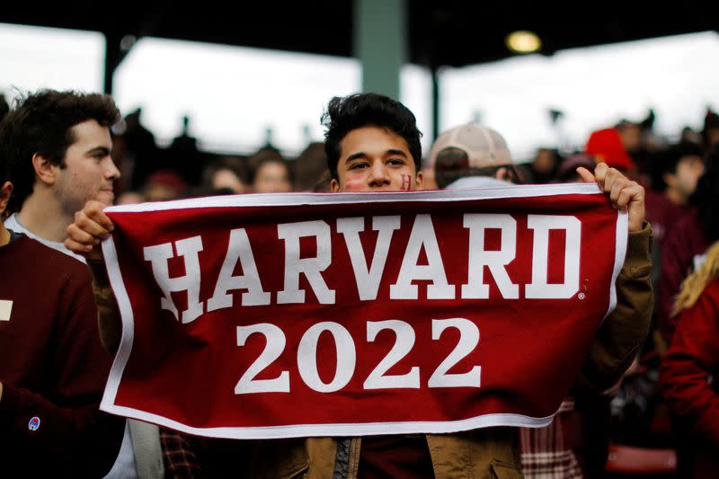 FILE PHOTO: A Harvard University student cheers during the 135th playing of "The Game" against Yale University, at Fenway Park in Boston