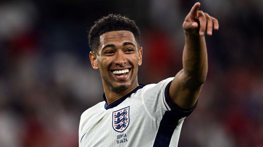 Jude Bellingham smiles and points in England uniform