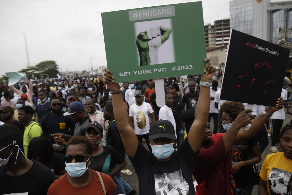 FILE- People hold banners as they demonstrate on the street to protest against police brutality in Lagos, Nigeria, Friday Oct. 16, 2020. In a report submitted to Lagos Governor Babajide Sanwo-Olu on Monday, Nov. 15, 2021, a Nigerian judicial panel has found that soldiers of the Nigerian army "shot, injured and killed" protesters during the Oct. 2020 nationwide demonstrations against police brutality in the country's most populous city Lagos. (AP Photo/Sunday Alamba, File)