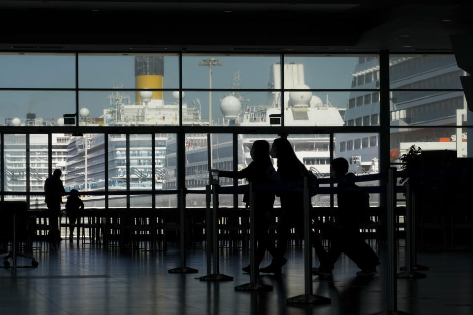 Passengers walk the terminal prior to boarding the MSC Grandiosa cruise ship in Civitavecchia, near Rome, Wednesday, March 31, 2021. MSC Grandiosa, the world's only cruise ship to be operating at the moment, left from Genoa on March 30 and stopped in Civitavecchia near Rome to pick up more passengers and then sail toward Naples, Cagliari, and Malta to be back in Genoa on April 6. For most of the winter, the MSC Grandiosa has been a lonely flag-bearer of the global cruise industry stalled by the pandemic, plying the Mediterranean Sea with seven-night cruises along Italy’s western coast, its major islands and a stop in Malta. (AP Photo/Andrew Medichini)