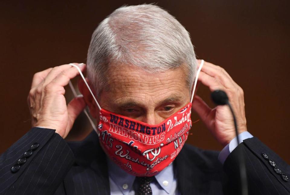 Dr. Anthony Fauci, director of the National Institute for Allergy and Infectious Diseases, lowers his face mask as he prepares to testify before a Senate Health, Education, Labor and Pensions Committee hearing on Capitol Hill in Washington, Tuesday, June 30, 2020.