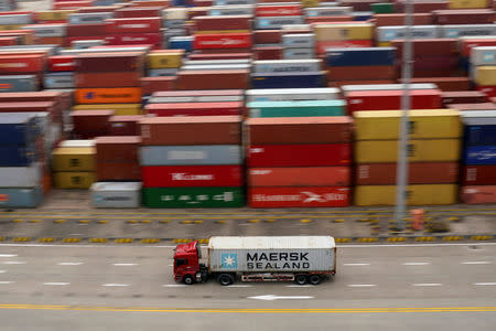 FILE PHOTO: A container truck moves past containers at the Yangshan Deep Water Port in Shanghai, China April 24, 2018. REUTERS/Aly Song/File Photo