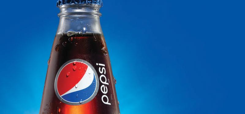 A glass Pepsi bottle over blue background.