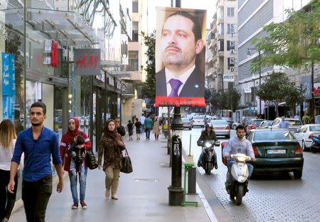 A poster showing Lebanese Prime Minister Saad al-Hariri, who announced his resignation from Saudi Arabia, is seen in Beirut, Lebanon, November 15, 2017. Words on poster reads "We are all with you". REUTERS/Jamal Saidi