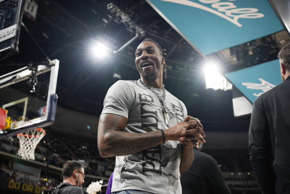 Los Angeles Lakers center Dwight Howard jokes with fans in the first half of an basketball game against the Denver Nuggets Sunday, April 10, 2022, in Denver. (AP Photo/David Zalubowski)