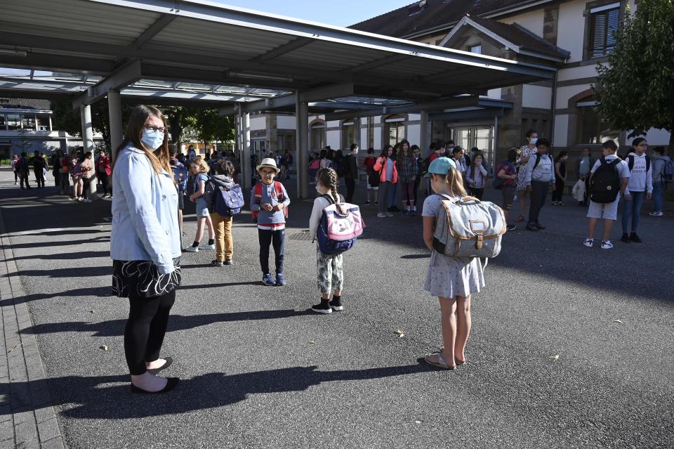 Children line up to enter their classrooms at the Ziegelau elementary school in Strasbourg, France, as primary and middle schools reopen June 22.