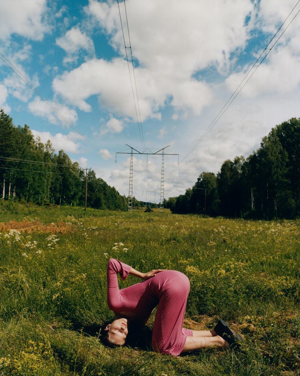 Adela wears a vintage Isabel Marant dress, standing underneath a power line.