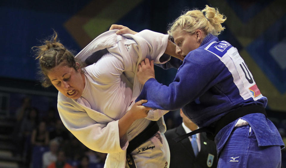 Kayla Harrison of the U.S. (blue) battles Catherine Roberge of Canada to win the gold medal in the women's -78kg judo contest at the Pan American Games in Guadalajara October 27,2011. REUTERS/Mariana Bazo