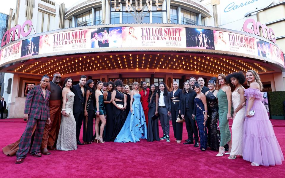 Taylor Swift with her dancers and band at the premiere for The Eras Tour concert film