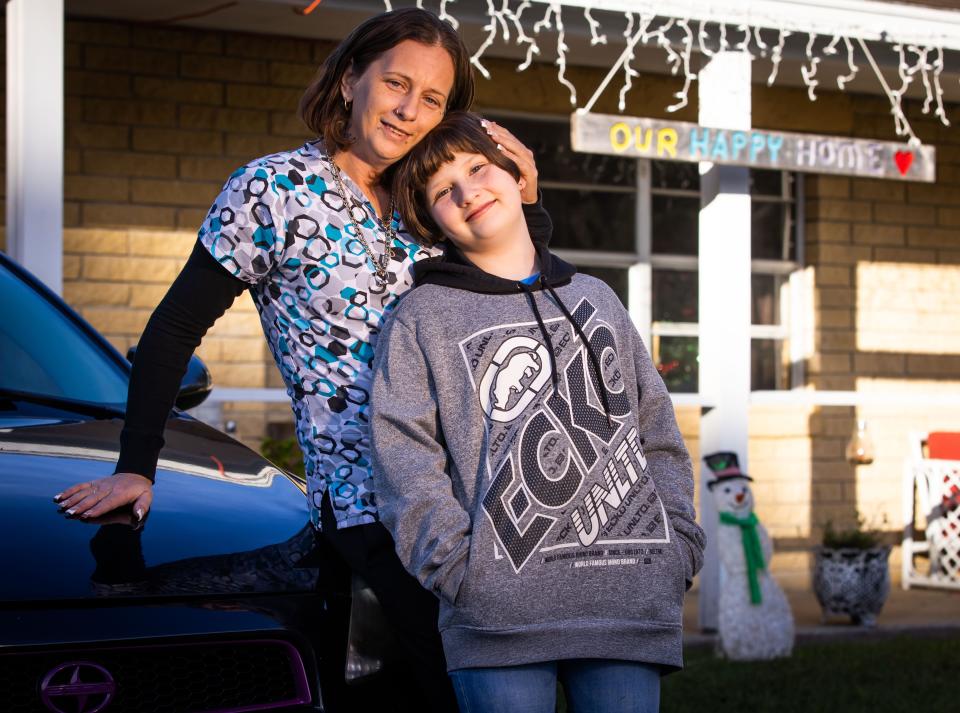 Casaundra "Cassie" Park poses with her daughter Miley, 10, in front of their home in Ocala on Nov. 28.