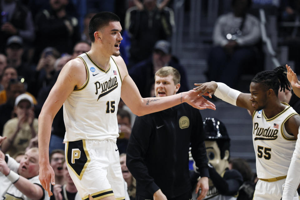 Purdue center Zach Edey (15) is greeted by guard Lance Jones (55) as he heads to the bench during the second half of a Sweet 16 college basketball game against Gonzaga in the NCAA Tournament, Friday, March 29, 2024, in Detroit. (AP Photo/Duane Burleson)