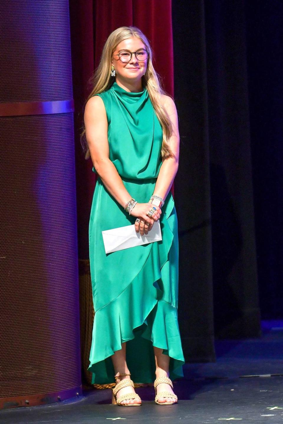 Mia Bell of Central High School stands on the Bill Heard Theatre stage at the RiverCenter for the Performing Arts in Columbus after she was announced as the journalism category winner during the Page One Awards ceremony April 9, 2024,