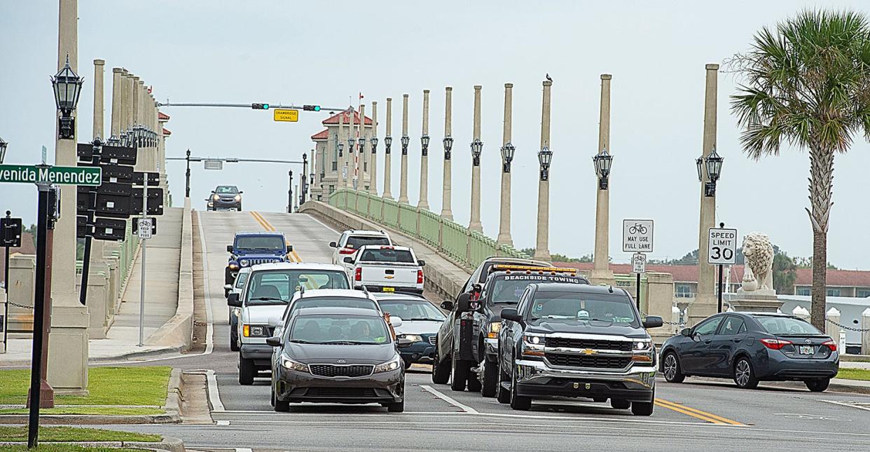 Vehicles wait at the traffic light on the west side of the Bridge of Lions.