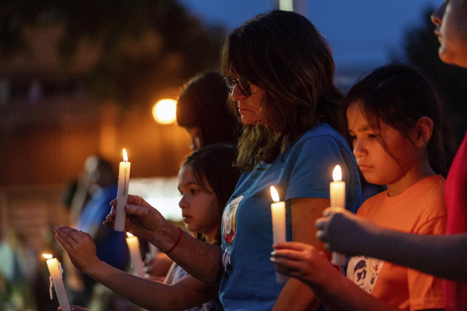 People hold candles at a vigil in honor of the victims of a mass stabbing incident at James Smith Cree Nation and Weldon, Saskatchewan, in front of City Hall in Prince Albert, Saskatchewan, on Wednesday, Sept. 7, 2022. (Heywood Yu/The Canadian Press via AP)