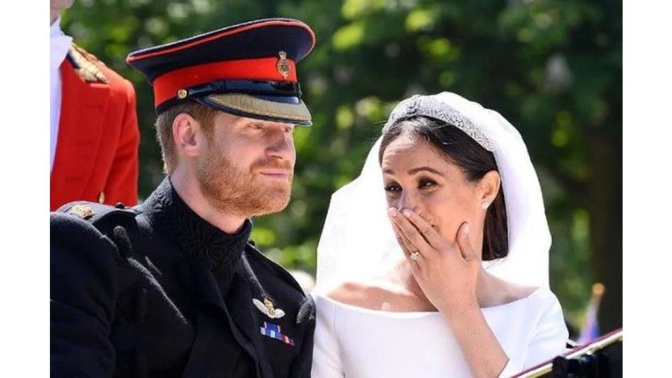 Meghan Markle covering her mouth as she laughs on her wedding day