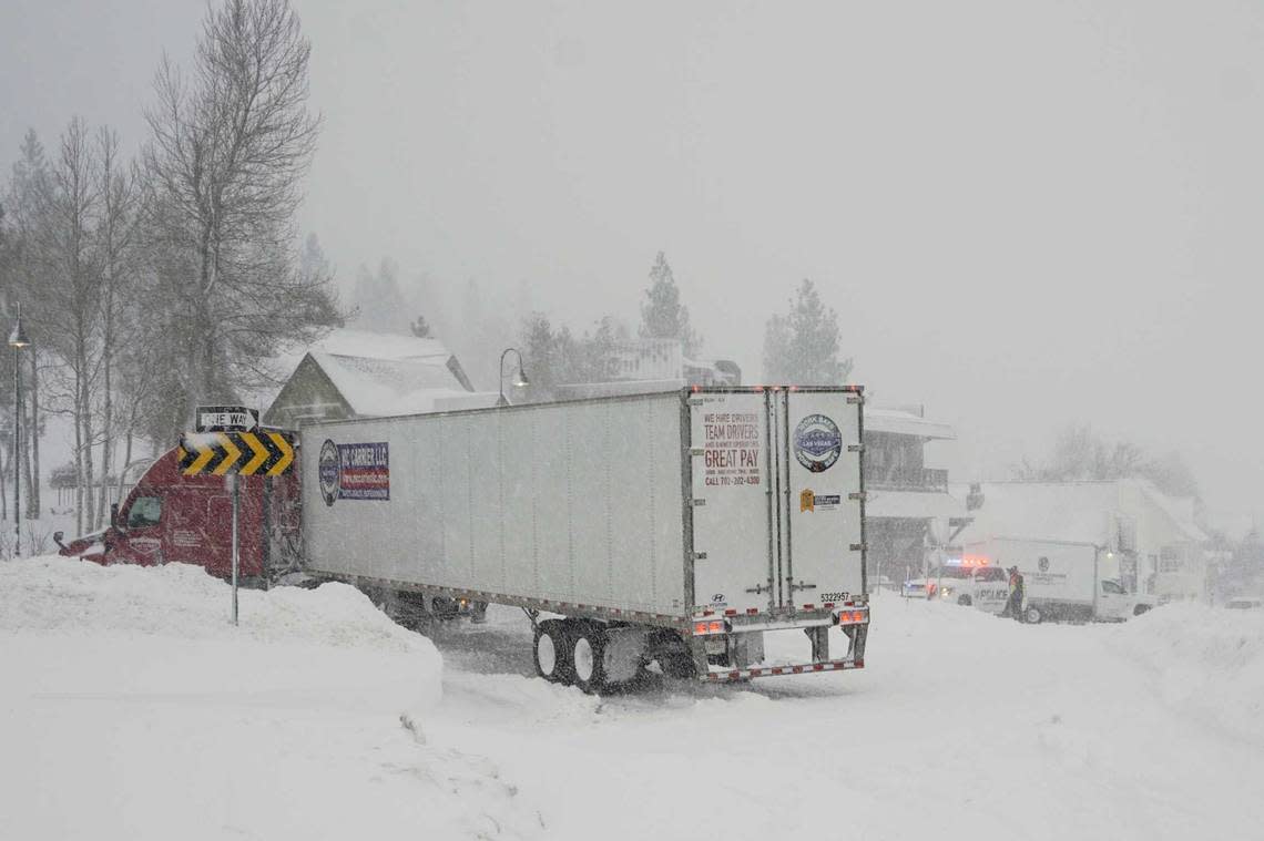 Vehicles make their way along a snow-covered road during a storm, Saturday, March 2, 2024, in Truckee, Calif. A powerful blizzard howled Saturday in the Sierra Nevada as the biggest storm of the season shut down a long stretch of Interstate 80 in California and gusty winds and heavy rain hit lower elevations, leaving tens of thousands of homes without power. Brooke Hess-Homeier/AP