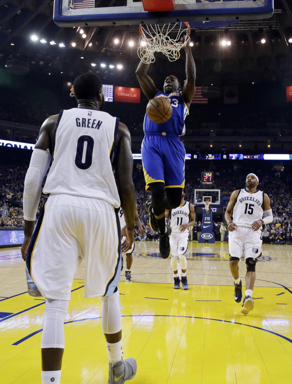 Golden State Warriors' Draymond Green, top, dunks past Memphis Grizzlies' JaMychal Green (0) and Vince Carter (15) during the first half of an NBA basketball game Sunday, March 26, 2017, in Oakland, Calif. (AP Photo/Marcio Jose Sanchez)