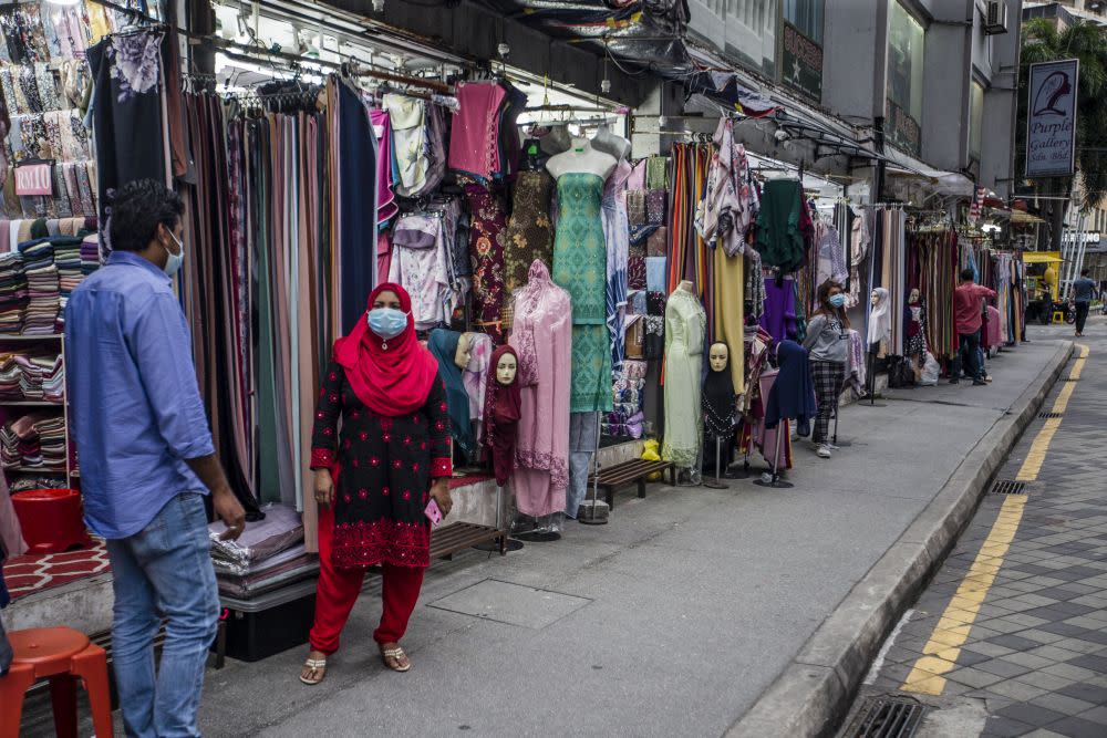 Street vendors are seen waiting for customers in front of their shops on Jalan Tuanku Abdul Rahman amid the conditional movement control order in Kuala Lumpur October 23, 2020. — Picture by Firdaus Latif