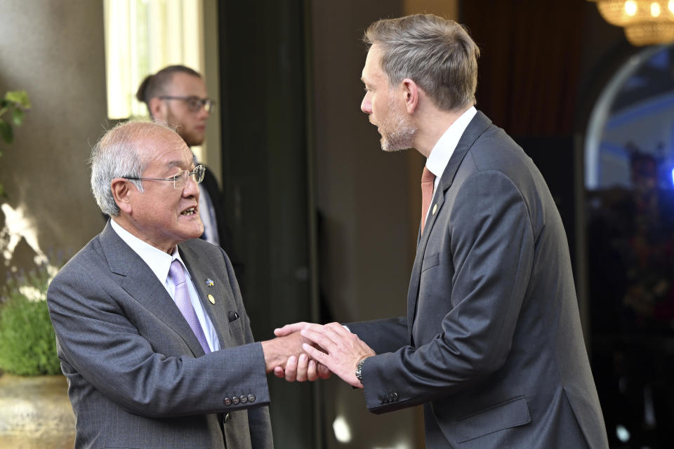 German Finance Minister Christian Lindner, right, welcomes the Finance Minister of Japan, Shunichi Suzuki, left, for a G7 Finance Ministers Meeting at the federal guest house Petersberg, near Bonn, Germany, Thursday, May 19, 2022. (Federico Gambarini/dpa via AP)