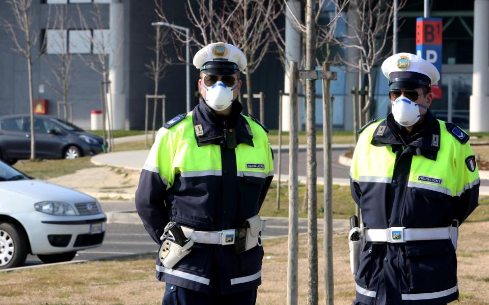 Police on guard at the hospital near Padova where tests for the coronavirus are performed on the population in Veneto region, northern Italy - NICOLA FOSSELLA/EPA-EFE/REX