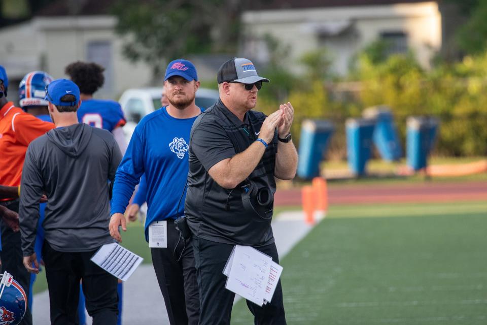 Savannah State head coach Shawn Quinn cheers on his team after the Tigers scored a touchdown.