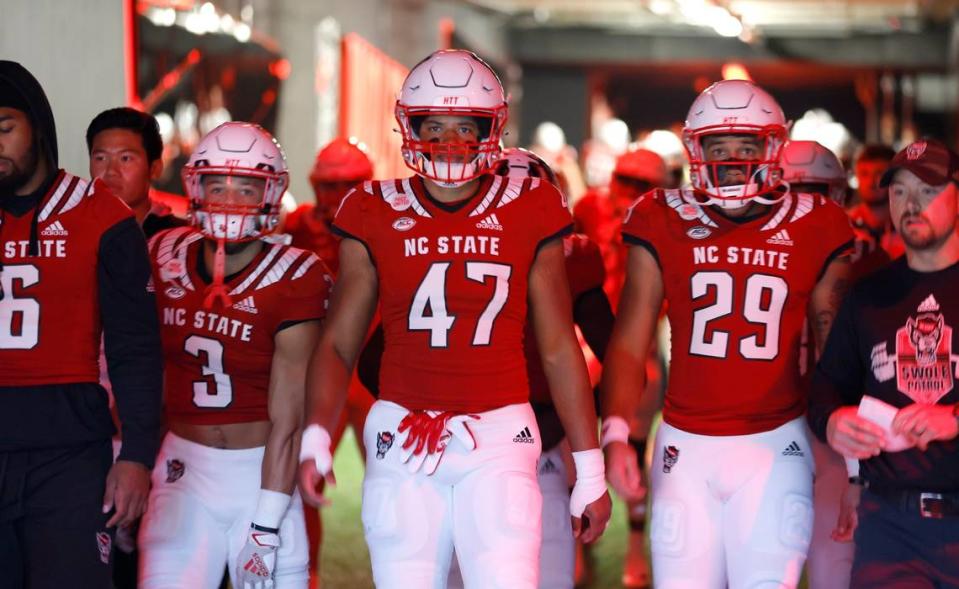 N.C. State’s Jordan Houston (3), Ced Seabrough (47) and Christopher Toudle (29) head out of the tunnel to warmup before N.C. State’s game against Florida State at Carter-Finley Stadium in Raleigh, N.C., Saturday, Oct. 8, 2022.