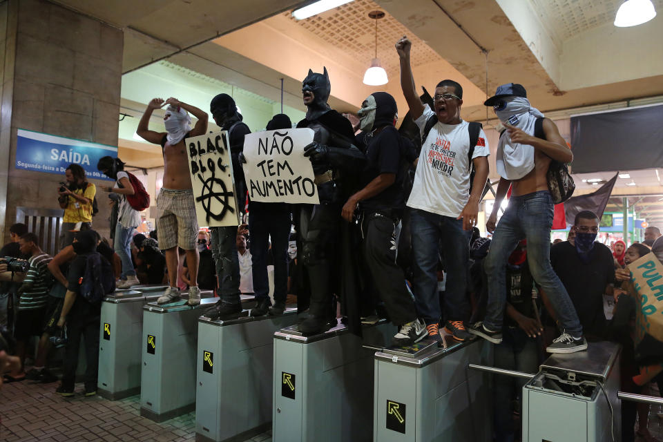 Protesters invade the central train station in protest against the increase of bus fares in Rio de Janeiro, Brazil, Thursday, Feb. 6, 2014. Last year, millions of people took to the streets across Brazil complaining of higher bus fares, poor public services and corruption while the country spends billions on the World Cup, which is scheduled to start in June. (AP Photo/Leo Correa)