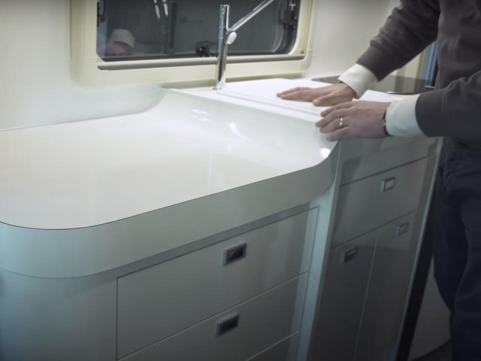 the kitchen countertop and a person standing next to it