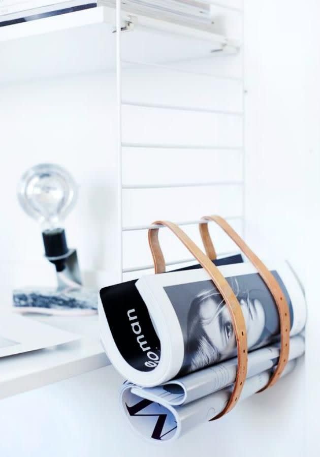 Create a little extra storage tucked neatly underneath a shelf with a simple luggage strap or belt. Source: Pinterest/ weekdaycarnival