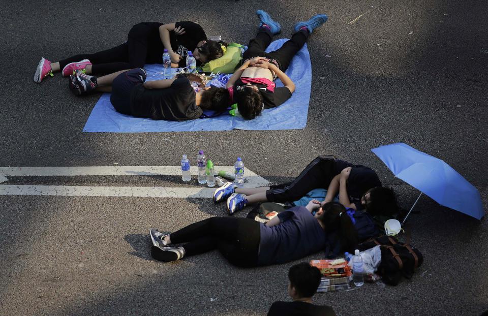 Student activists sleep on a road near the government headquarters where pro-democracy activists have gathered and made camp, Tuesday, Sept. 30, 2014 in Hong Kong. (AP Photo/Wong Maye-E)