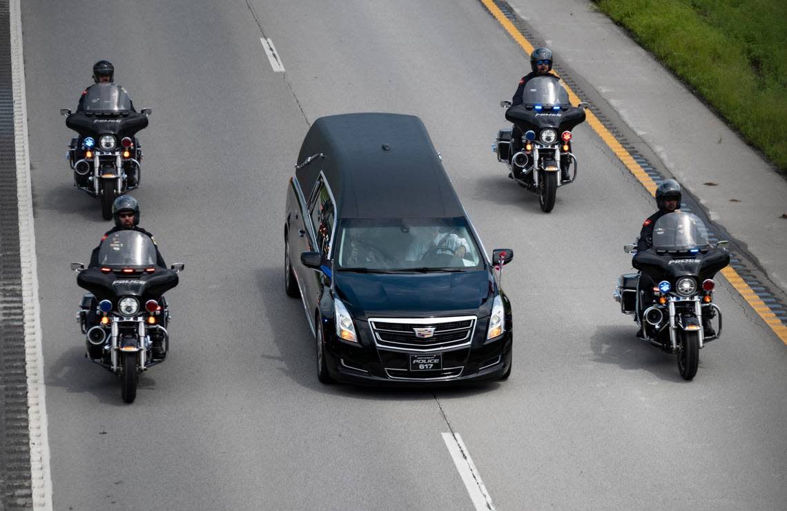 The hearse carrying North Kansas City police officer Daniel Vasquez’s body drives to White Chapel Memorial Gardens during the funeral procession for Wednesday, July 27, 2022, in Kansas City. Vasquez was shot and killed while on duty last week in North Kansas City.
