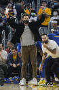 Injured Golden State Warriors guard Klay Thompson celebrates after a teammate scored against the Memphis Grizzlies during the first half of an NBA basketball game in San Francisco, Thursday, Oct. 28, 2021. (AP Photo/Jeff Chiu)