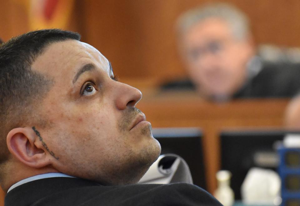 Defendant Nelson Coelho looks at evidence during his trial for the 2021 murder of Lal Kishor Mahaseth on Thursday, May 2, 2024.