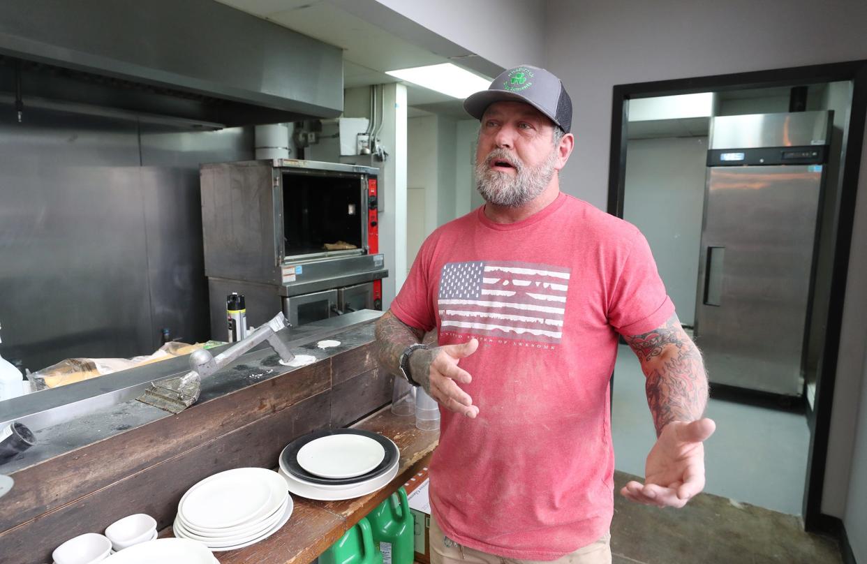 Co-owner Mark Mickey talks about the renovations at his new venture Mickey's Irish Pub and Pavona's Pizza Joint in Cuyahoga Falls in January. Mickey is schedule to stand trail on an arson charge Feb. 29.