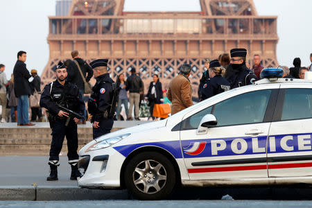 Police patrol at the Trocadero near the Eiffel Tower after a policeman was killed and two others were wounded in a shooting incident in Paris, France, April 21, 2017. REUTERS/Charles Platiau