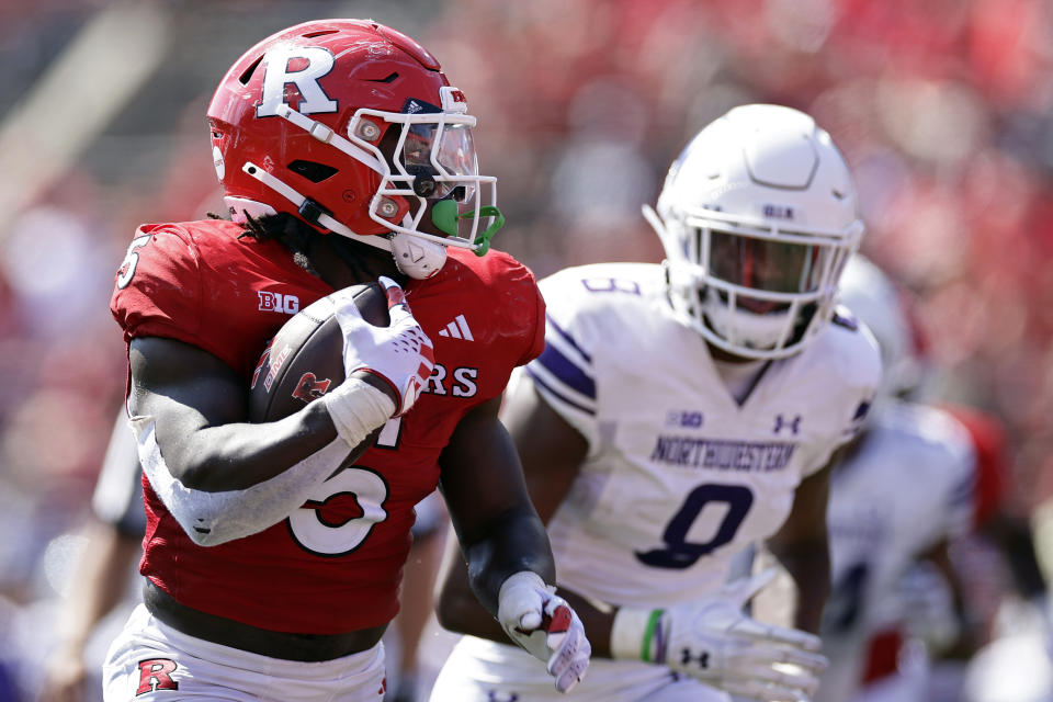 Rutgers running back Kyle Monangai rushes for a touchdown past Northwestern defensive back Devin Turner during the second half of an NCAA college football game, Sunday, Sept. 3, 2023, in Piscataway, N.J. (AP Photo/Adam Hunger)